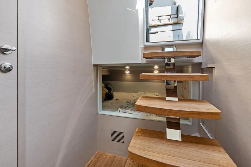  Yacht Photos Pics Interior of 2025 SACS 40 Rebel yacht with modern wooden staircase and cozy cabin.