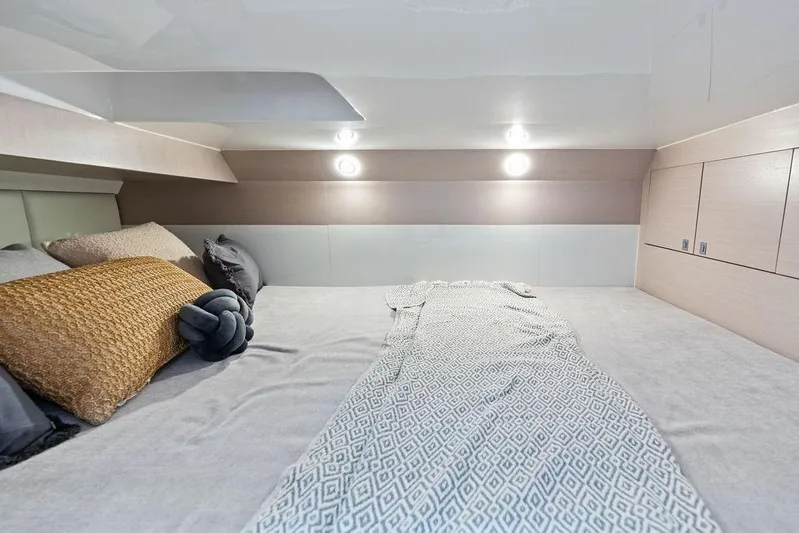  Yacht Photos Pics Luxurious cabin interior of 2025 SACS 40 Rebel with cozy bedding and ambient lighting.