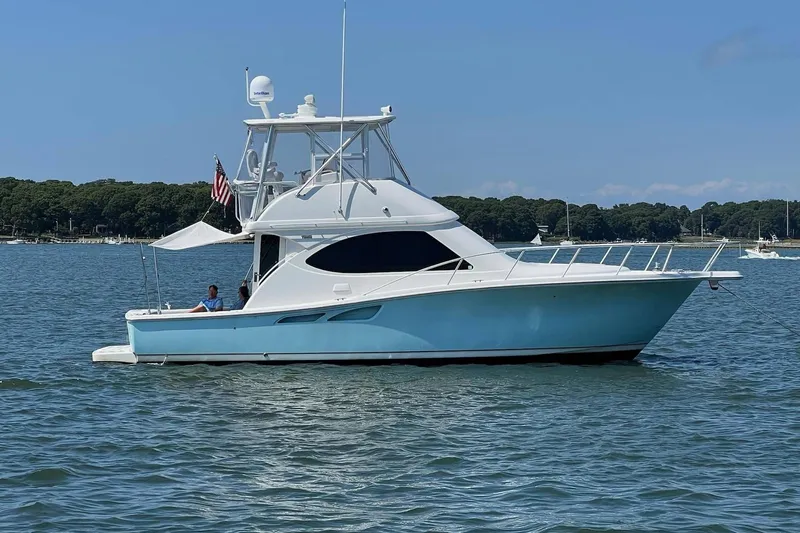 Follow That Stern Ix Yacht Photos Pics 2007 Tiara Yachts 3900 Convertible on calm water, featuring sleek design and American flag.