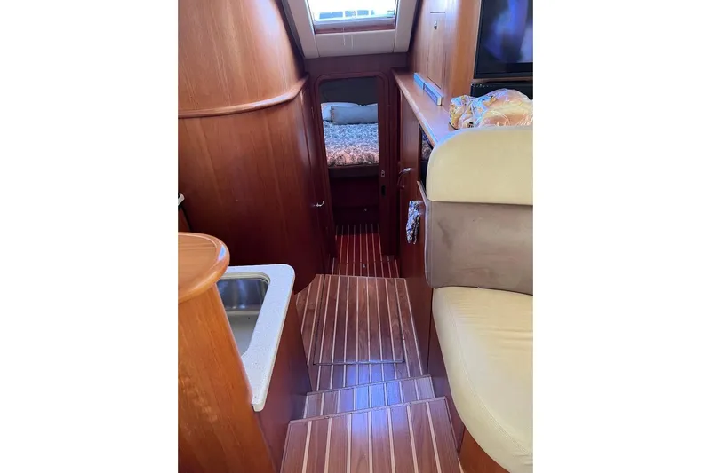 Follow That Stern Ix Yacht Photos Pics Interior of 2007 Tiara Yachts 3900 Convertible, featuring wood paneling and cozy cabin space.