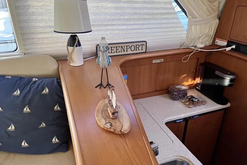 Follow That Stern Ix Yacht Photos Pics Interior of 2007 Tiara Yachts 3900 Convertible with cozy decor and kitchen area.