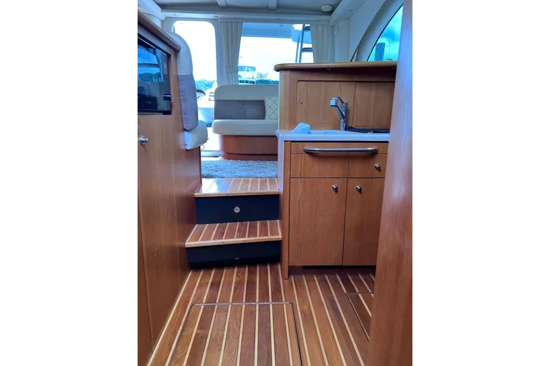 Follow That Stern Ix Yacht Photos Pics Interior of 2007 Tiara Yachts 3900 Convertible with wooden flooring and compact kitchen area.