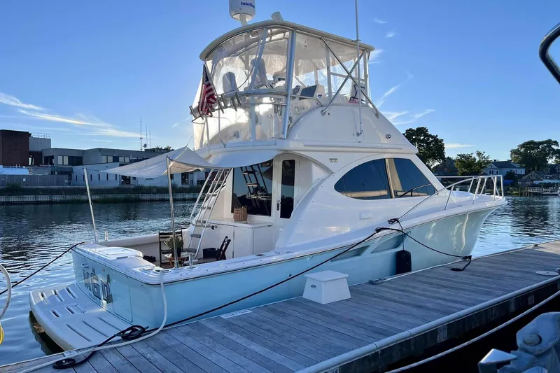 Follow That Stern Ix Yacht Photos Pics 2007 Tiara Yachts 3900 Convertible docked at a marina under clear blue skies.