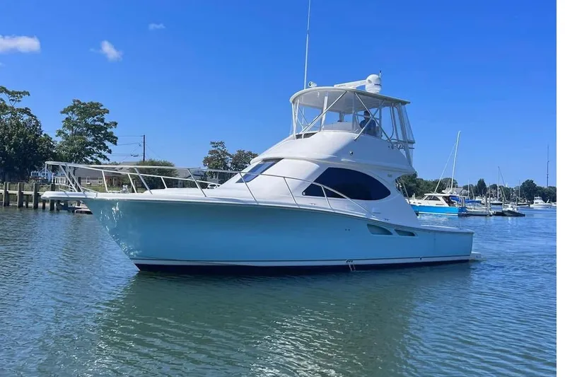 Follow That Stern Ix Yacht Photos Pics 2007 Tiara Yachts 3900 Convertible boat on calm water, clear blue sky background.