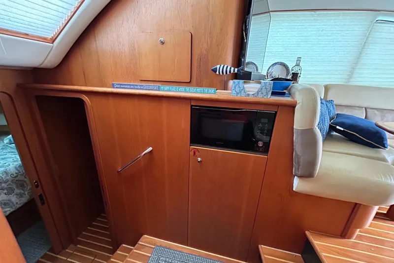 Follow That Stern Ix Yacht Photos Pics 2007 Tiara Yachts 3900 Convertible interior with wood cabinetry and cozy seating area.