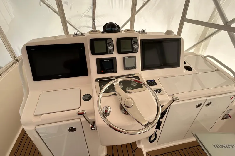 Follow That Stern Ix Yacht Photos Pics Helm of 2007 Tiara Yachts 3900 Convertible with navigation screens and controls.