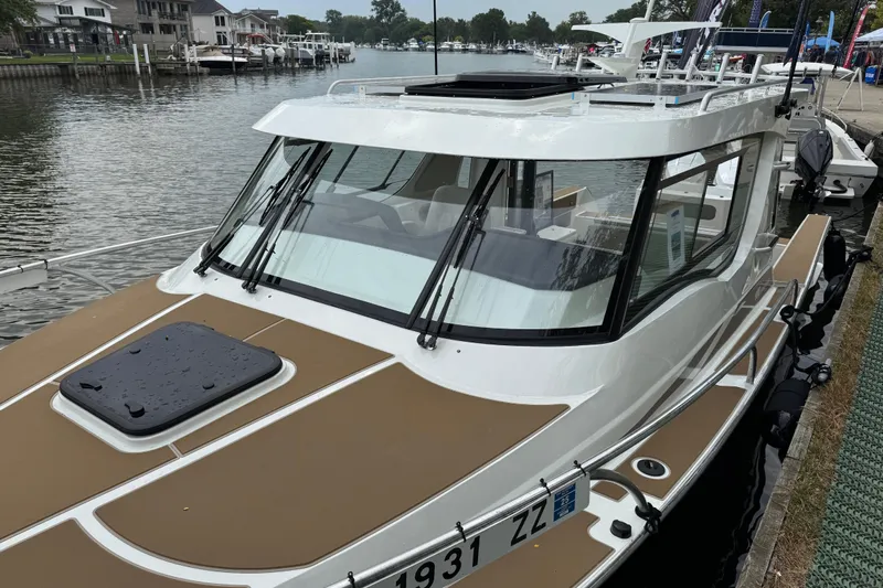  Yacht Photos Pics 2025 Extreme Boats 986 Game King docked by a waterfront, showcasing sleek design.