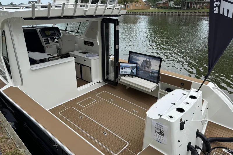  Yacht Photos Pics 2025 Extreme Boats 986 Game King with spacious deck and modern interior on a calm waterway.