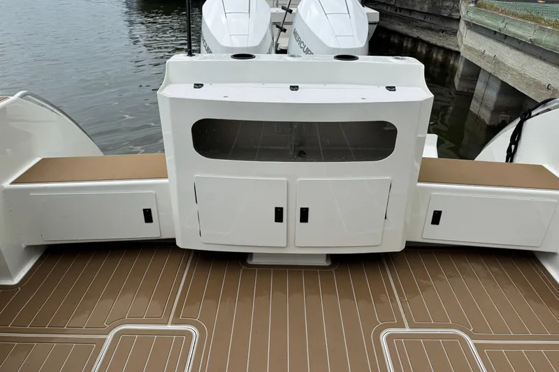  Yacht Photos Pics 2025 Extreme Boats 986 Game King deck with storage compartments and outboard motor.