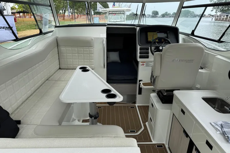  Yacht Photos Pics Interior of 2025 Extreme Boats 986 Game King, featuring seating, helm, and kitchenette.