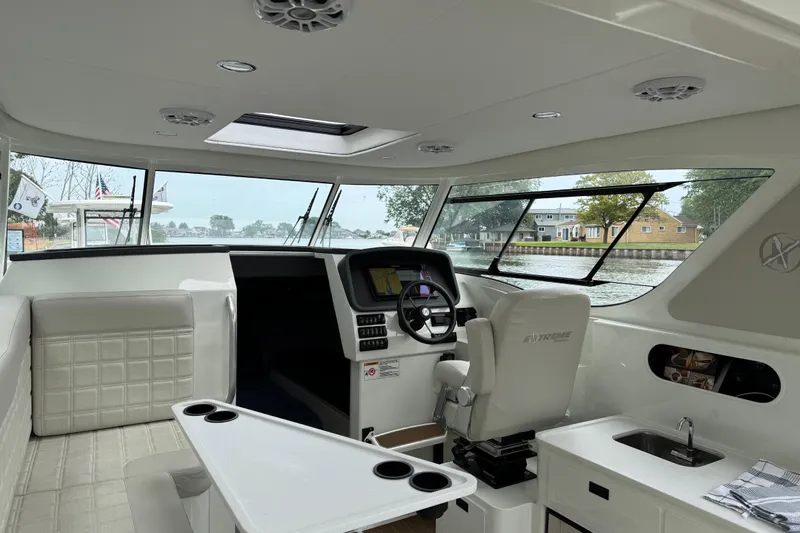 Yacht Photos Pics Interior of 2025 Extreme Boats 986 Game King, featuring helm and seating area.