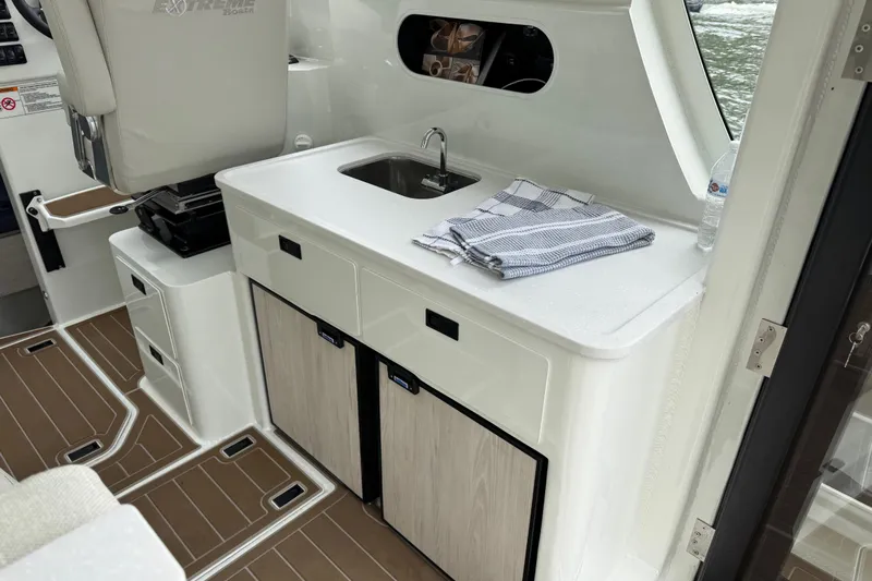  Yacht Photos Pics Interior of 2025 Extreme Boats 986 Game King with sink and storage cabinets.