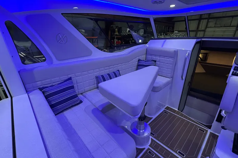 Yacht Photos Pics 2025 Extreme Boats 986 Game King interior with modern seating and ambient blue lighting.