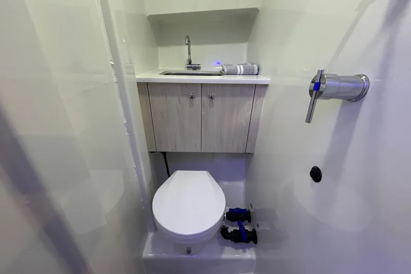  Yacht Photos Pics 2025 Extreme Boats 986 Game King bathroom with modern sink and toilet setup.