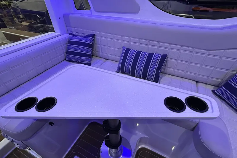  Yacht Photos Pics Interior of 2025 Extreme Boats 986 Game King with cushioned seating and table.
