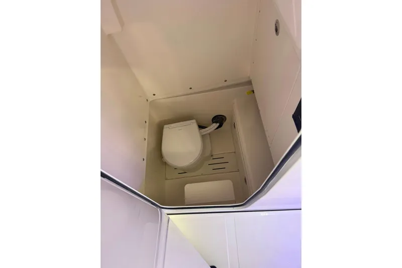  Yacht Photos Pics Interior view of 2026 Pioneer 250 Pelagic boat's compact bathroom with toilet.