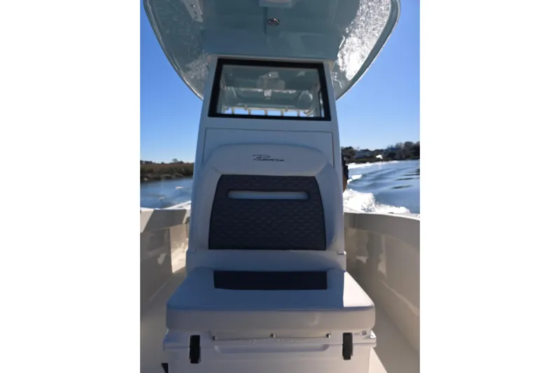  Yacht Photos Pics 2026 Pioneer boat interior with cushioned seating, navigating a sunny waterway.