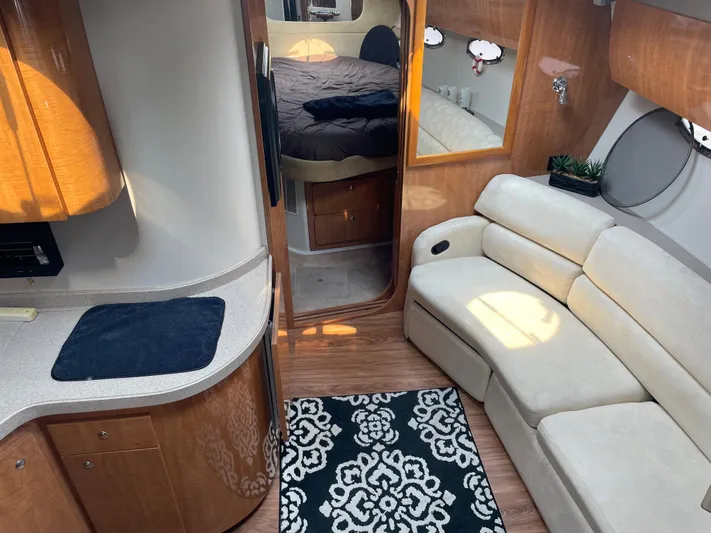  Yacht Photos Pics Interior of 2003 Regal 3860 Commodore yacht with sofa, kitchenette, and bedroom.