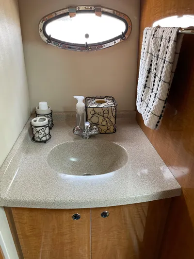  Yacht Photos Pics 2003 Regal 3860 Commodore yacht bathroom with sink, towel, and decorative accessories.