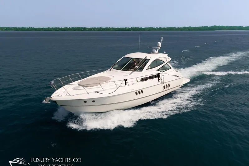  Yacht Photos Pics 2015 Cruisers Yachts 540 sailing on open water, showcasing sleek design and luxury.
