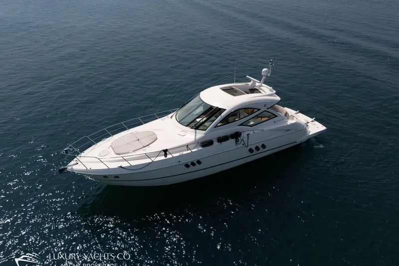  Yacht Photos Pics Luxury 2015 Cruisers Yachts 540 on serene blue waters.