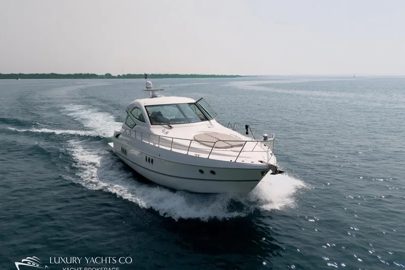  Yacht Photos Pics 2015 Cruisers Yachts 540 sailing on open water, showcasing sleek design and luxury.
