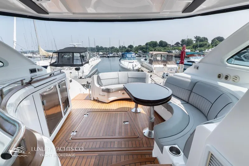  Yacht Photos Pics Luxurious 2015 Cruisers Yachts 540 interior with elegant seating and marina view.