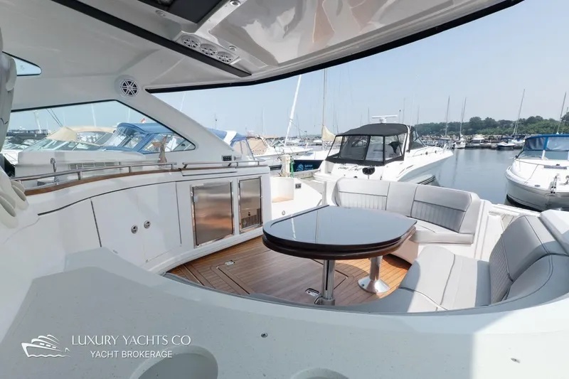  Yacht Photos Pics Luxurious 2015 Cruisers Yachts 540 with elegant seating and sleek design in a marina setting.
