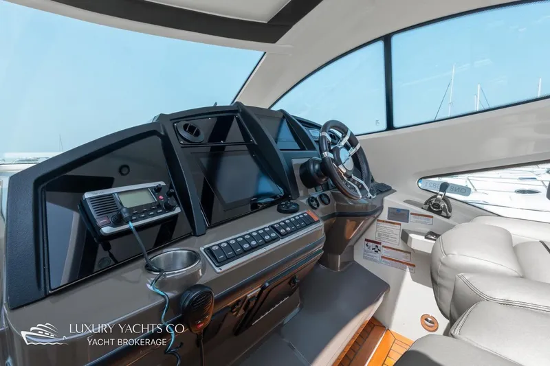  Yacht Photos Pics Helm of 2015 Cruisers Yachts 540 with modern controls and navigation equipment.