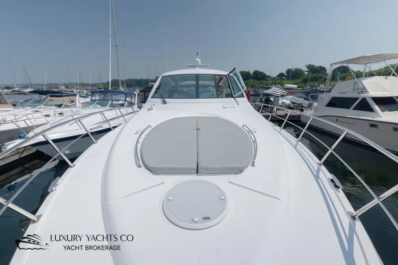  Yacht Photos Pics 2015 Cruisers Yachts 540 docked at marina, showcasing sleek design and spacious deck.