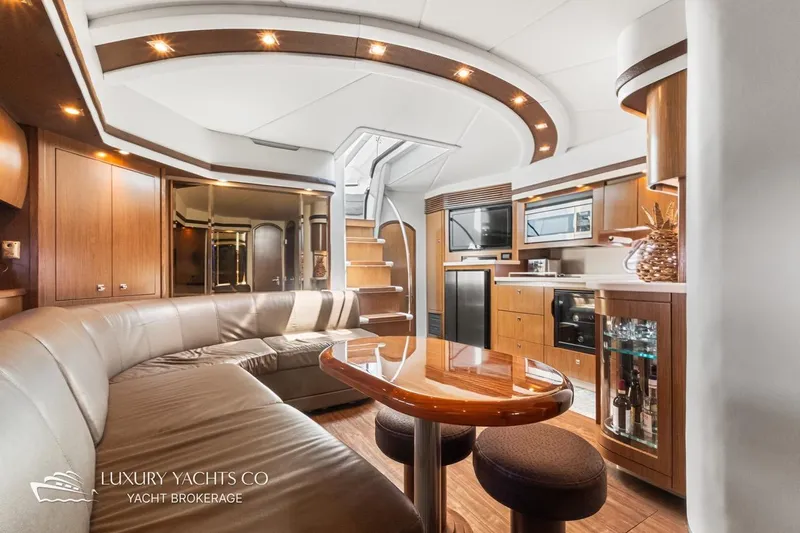  Yacht Photos Pics Luxurious interior of 2015 Cruisers Yachts 540 with modern kitchen and seating area.