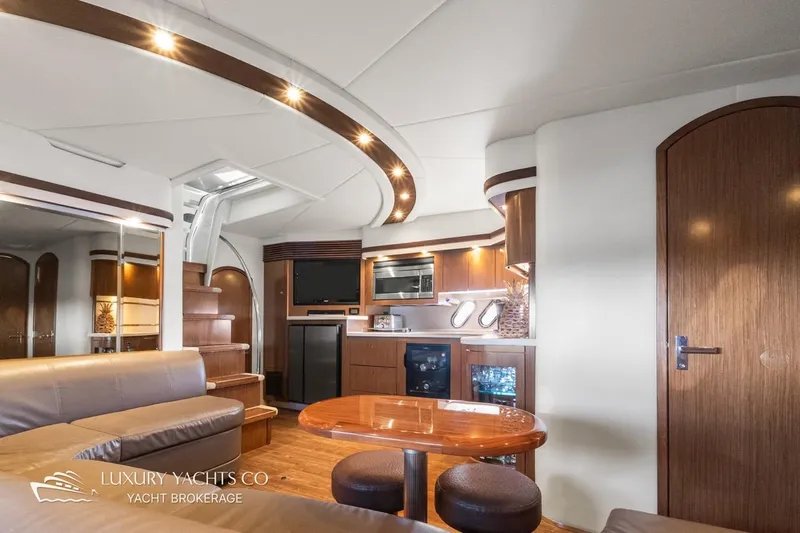  Yacht Photos Pics Luxurious interior of 2015 Cruisers Yachts 540 with modern kitchen and seating area.