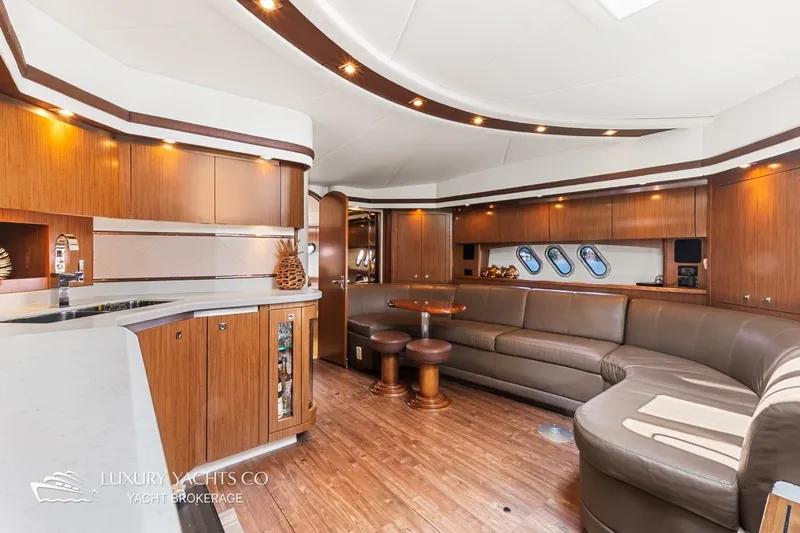  Yacht Photos Pics Luxurious interior of 2015 Cruisers Yachts 540 with elegant wood finishes and spacious seating.