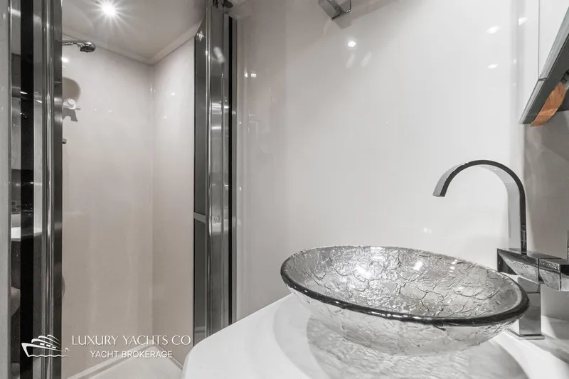  Yacht Photos Pics Luxurious bathroom in 2015 Cruisers Yachts 540, featuring elegant glass sink and modern fixtures.