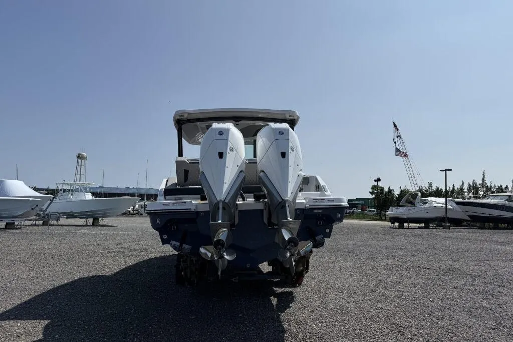 2026 Monterey Elite 30 OB boat with dual outboard engines in a marina setting.
