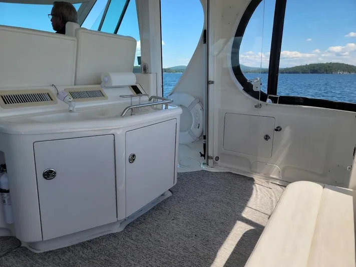  Yacht Photos Pics Interior of 2003 Sea Ray 390 Motor Yacht with white cabinetry and lake view.