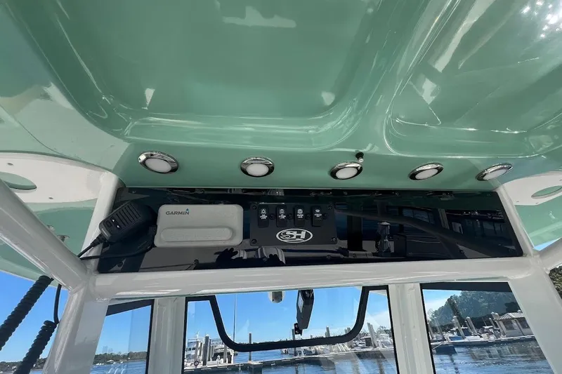 Wrecking Ball Yacht Photos Pics 2023 Sea Hunt Ultra 305 SE boat interior with Garmin equipment and overhead lighting.