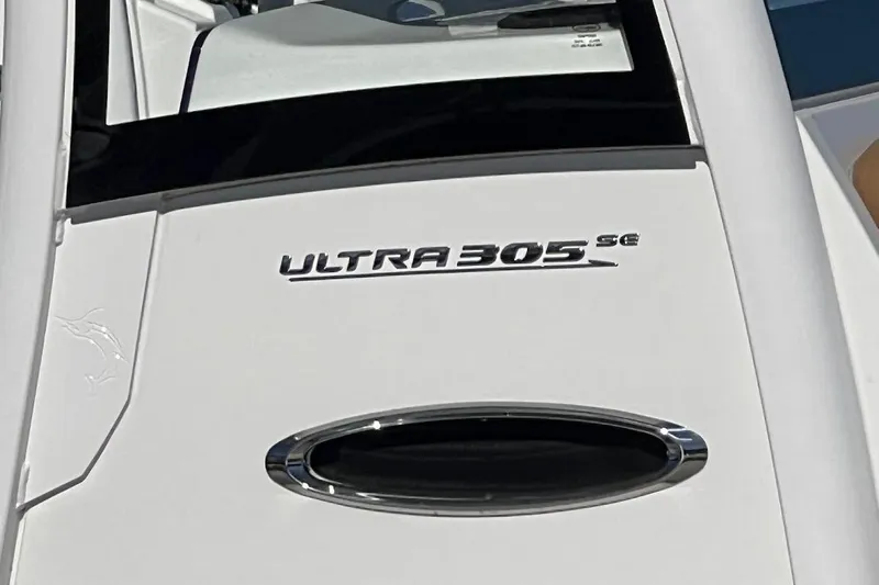 Wrecking Ball Yacht Photos Pics 2023 Sea Hunt Ultra 305 SE boat logo on white surface.