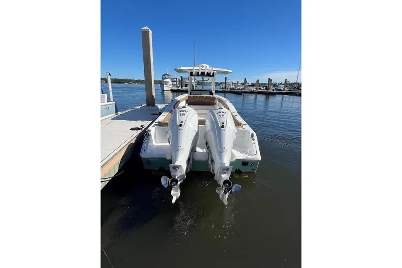 Wrecking Ball Yacht Photos Pics 2023 Sea Hunt Ultra 305 SE boat docked with twin engines, clear blue sky.