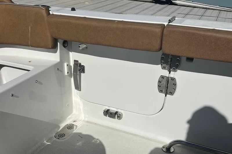 Wrecking Ball Yacht Photos Pics 2023 Sea Hunt Ultra 305 SE boat interior with brown seating and white paneling.