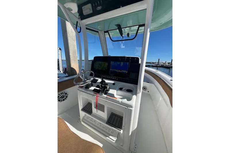 Wrecking Ball Yacht Photos Pics 2023 Sea Hunt Ultra 305 SE boat console with steering wheel and navigation screens.