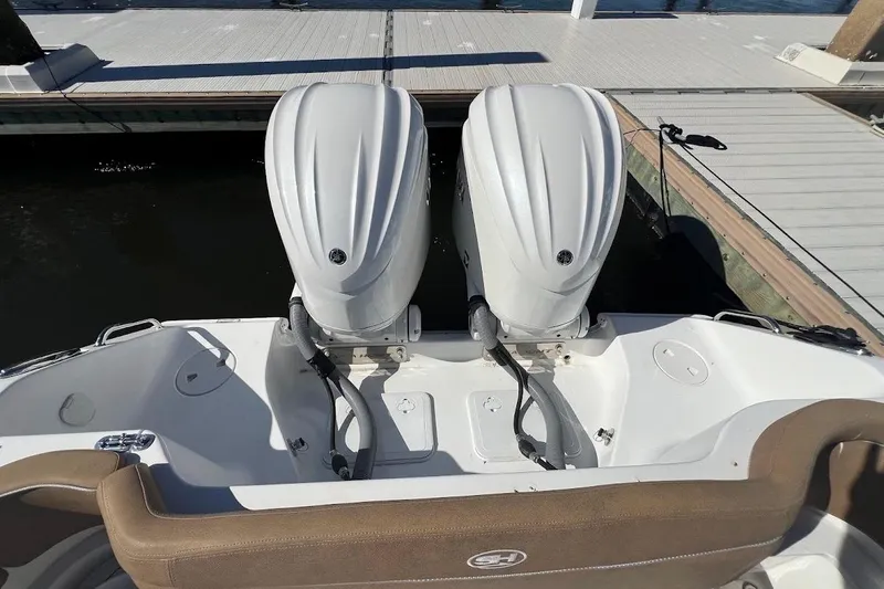 Wrecking Ball Yacht Photos Pics 2023 Sea Hunt Ultra 305 SE boat with dual outboard engines at dock.