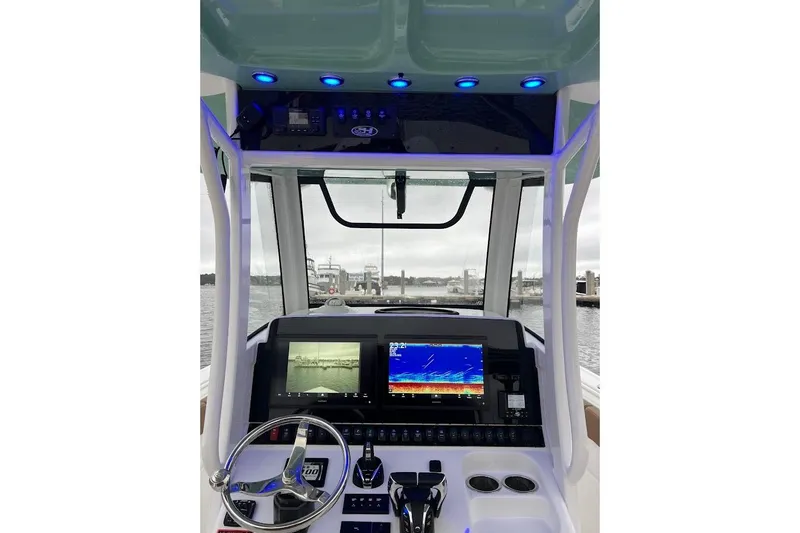 Wrecking Ball Yacht Photos Pics 2023 Sea Hunt Ultra 305 SE boat dashboard with navigation screens and steering wheel.