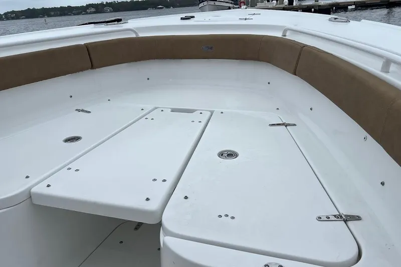 Wrecking Ball Yacht Photos Pics 2023 Sea Hunt Ultra 305 SE boat interior with cushioned seating and storage compartments.