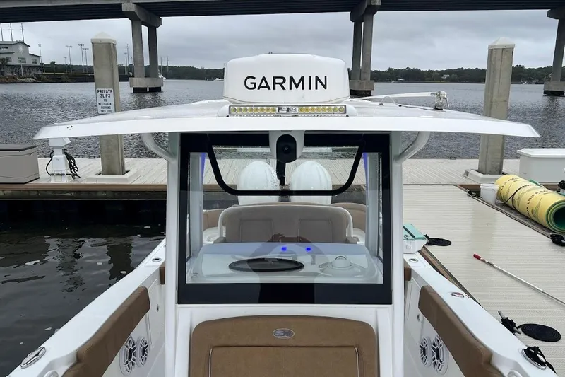 Wrecking Ball Yacht Photos Pics 2023 Sea Hunt Ultra 305 SE boat docked, featuring Garmin equipment and spacious seating.