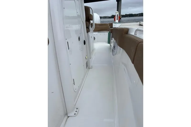 Wrecking Ball Yacht Photos Pics 2023 Sea Hunt Ultra 305 SE boat interior with white deck and brown seating.