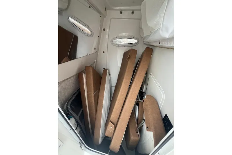 Wrecking Ball Yacht Photos Pics 2023 Sea Hunt Ultra 305 SE cabin interior with stacked cushions.