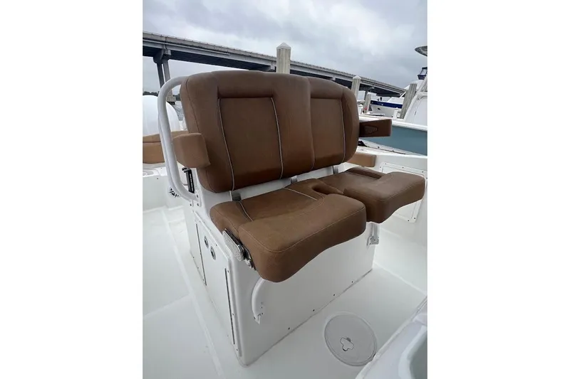 Wrecking Ball Yacht Photos Pics 2023 Sea Hunt Ultra 305 SE boat seating with brown cushions, white base, and armrests.