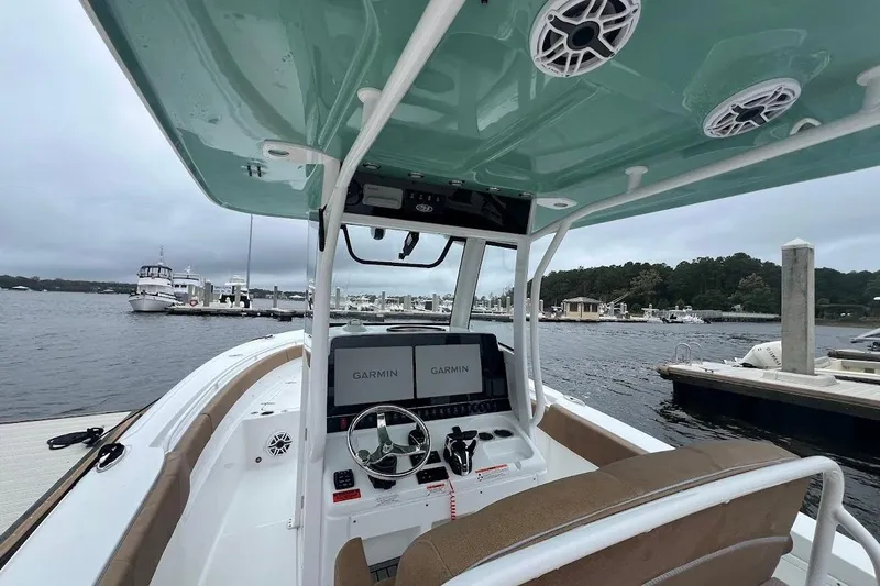 Wrecking Ball Yacht Photos Pics 2023 Sea Hunt Ultra 305 SE boat interior with Garmin navigation, docked at marina.
