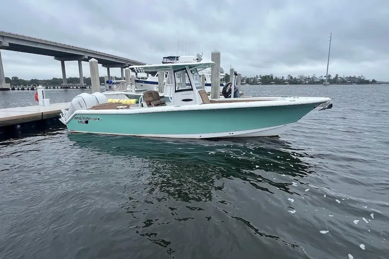 Wrecking Ball Yacht Photos Pics 2023 Sea Hunt Ultra 305 SE boat docked on a cloudy day.